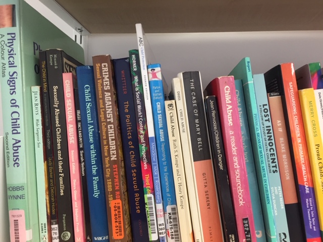 Textbooks on a shelf.
