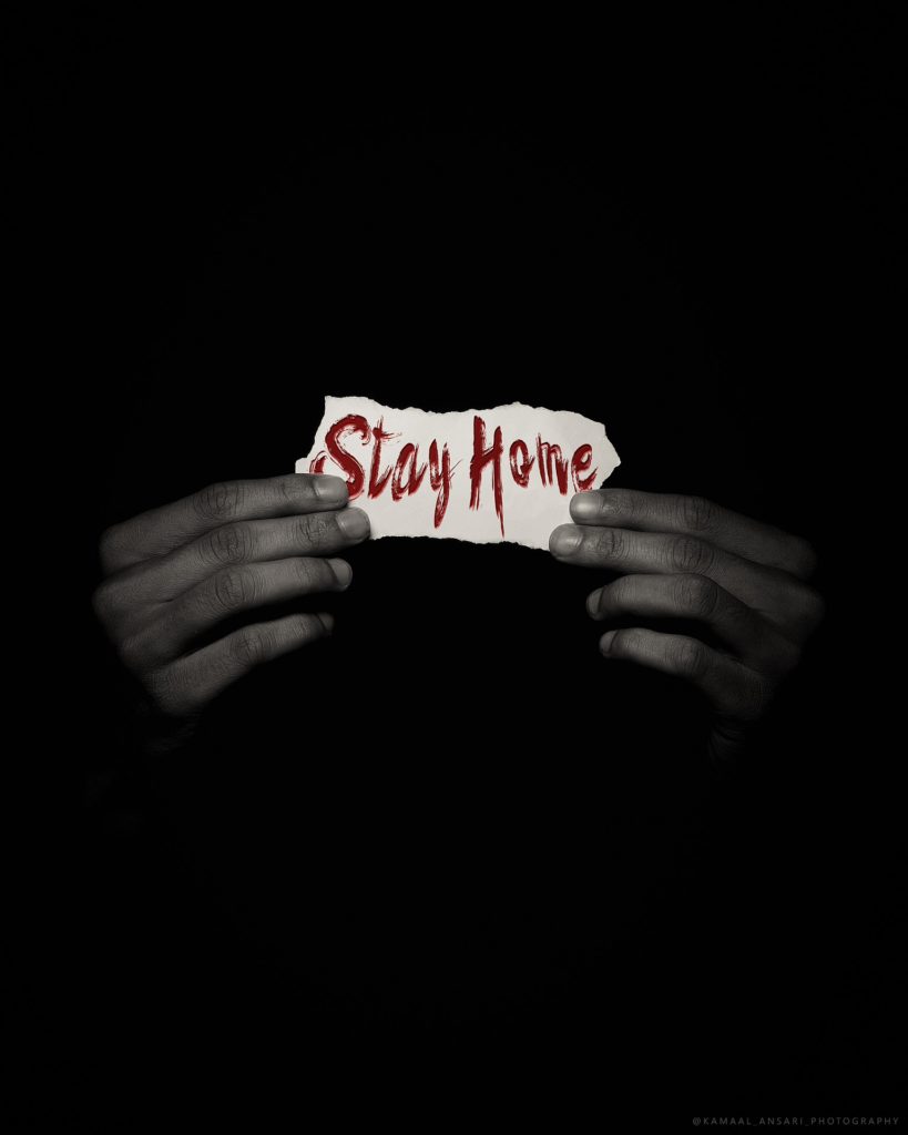 Hands holding 'stay home' sign. Image by Kamaal Ansari from Pixabay 